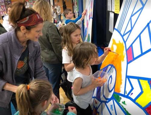 Students painting on a wall