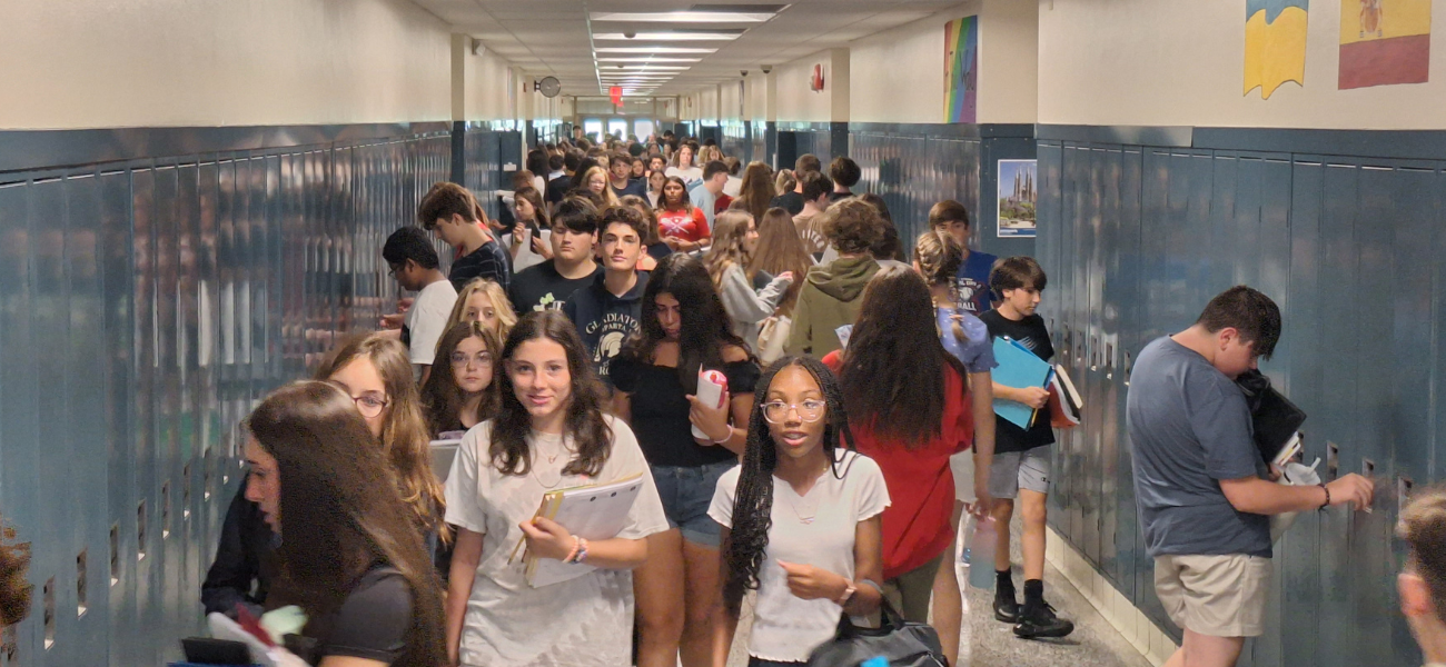 a group of young students painting a wall mural